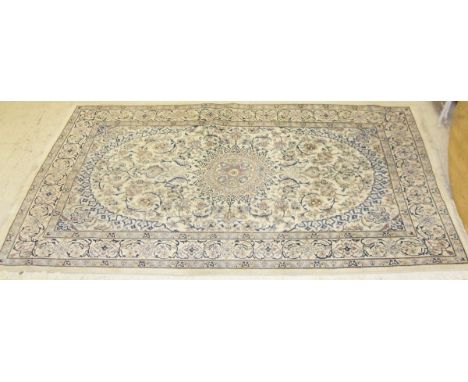 A Kashan carpet, the central panel set with floral decorated medallion on a mint ground with all-over scrolling floral decora