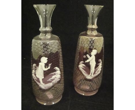 A pair of pale amethyst and white enamel decorated Mary Gregory style vases, one featuring a boy blowing bubbles, the other d
