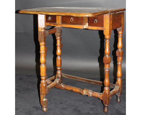 An 18th Century walnut single leaf side table, the top with moulded edge with single gate-leg  revealing three drawers, raise