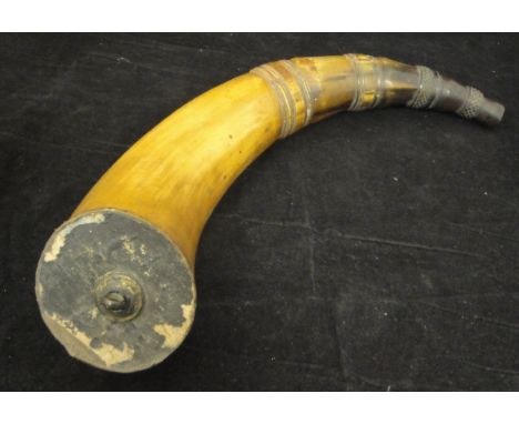 An inscribed cow horn flask, the spout carved with rings and faceted panels, the transluscent section inscribed within an inc