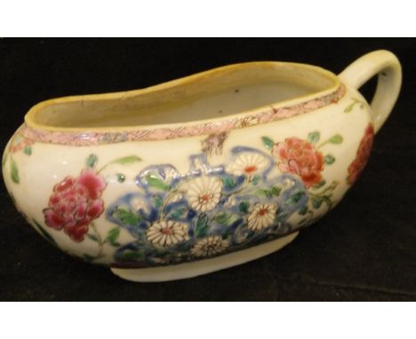 A 19th Century Chinese famille rose bourdaloue with all over floral spray decoration in enamels raised on a shaped foot, 23 c