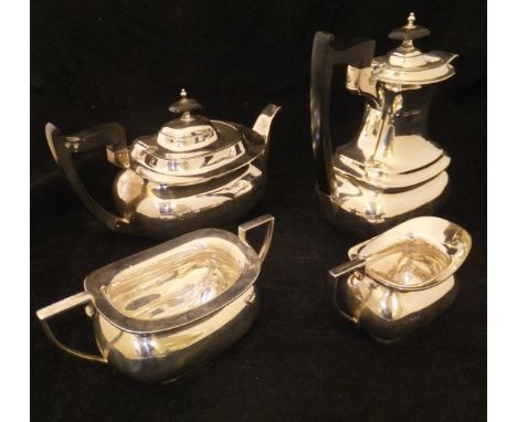 A George V silver four piece tea set comprising teapot, twin-handled sucrier, milk jug and hot water jug, all of rectangular 