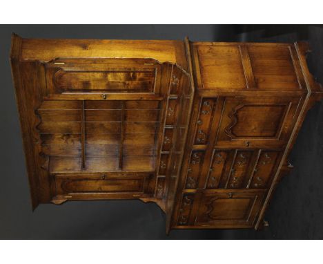 A 20th Century Brights of Nettlebed oak cross-banded dresser in the early 19th Century taste, the Cavetto moulded cornice abo