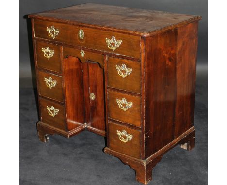 An 18th Century fruitwood kneehole desk, the plain top with moulded edge over a single long drawer and small drawer over a re