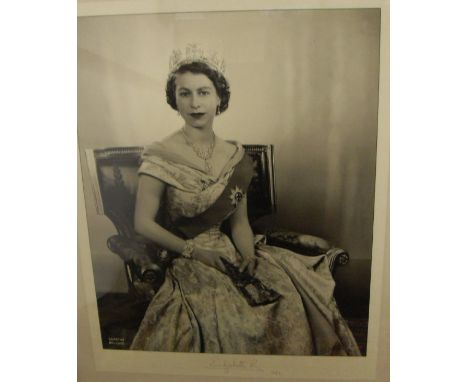 AFTER DOROTHY WILDING (1893-1976) "Queen Elizabeth II", a photographic portrait study, black and white, seated in formal dres