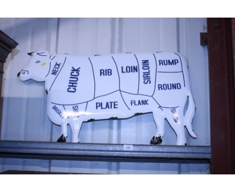 An enamel cow sign