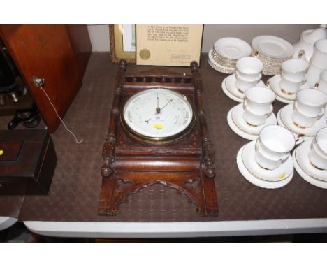 A late Victorian oak cased barometer