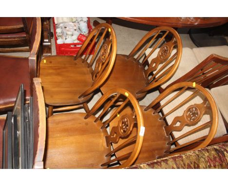 A set of four Ercol stick back dining chairs 