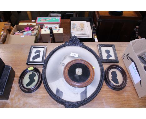 Four various silhouette portraits; a small plaster portrait profile; and an Edwardian photographic print in decorative frame 