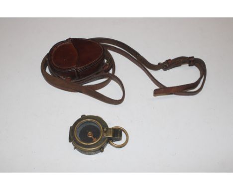 A brass compass dated 1917 with leather case, stamped R. Stafford 1918