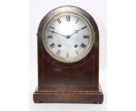 A late 19th century mahogany and boxwood strung cased domed top bracket clock having a convex silvered dial with Roman numera