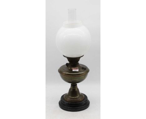 An early 20th century brass pedestal oil lamp, having opalescent globular shade, h.47cm