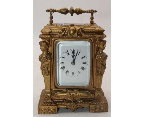 A 20th century gilt painted carriage clock, the enamel dial showing Roman numerals, height 15cm