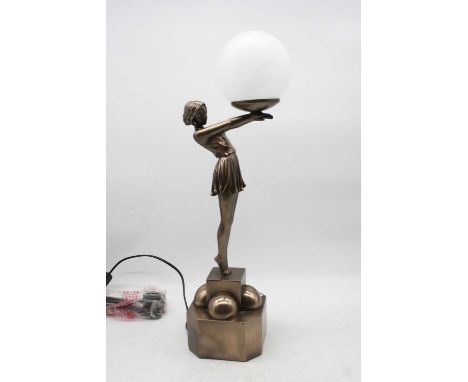 A reproduction Art Deco style table lamp in the form of a female dancer with outstretched arms holding a globular shade, heig