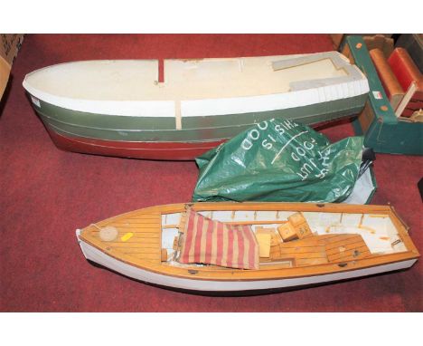 A fibreglass model ships hull, together with another similar