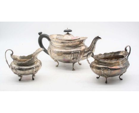 A matched Victorian silver three-piece tea service, the teapot of boat form having ebony handle, Birmingham 1863