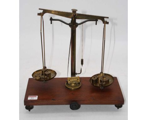 A set of Victorian brass beam scales, on mahogany plinth, bearing a plaque for W&amp;J George Ltd, FE Becker &amp; Co., Londo