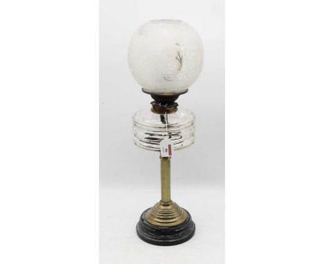 An early 20th century brass pedestal oil lamp, having opalescent globular shade and clear glass font, on a fluted column and 