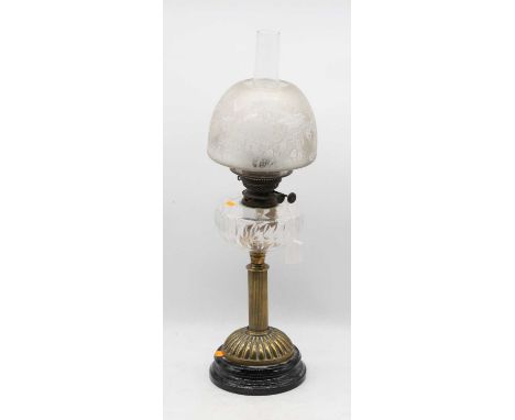 A late Victorian oil lamp, having etched opalescent shade above a clear glass font, on a fluted column, dome foot and socle b