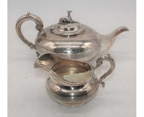 A Victorian silver teapot and cream jug, each of squat central banded form, with S-scroll handles (teapot with ivory insulato