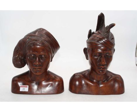 A pair of 20th century North African carved male and female head and shoulders portrait busts, height 30cm