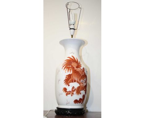 A large reproduction Chinese style table lamp, on a white ground decorated with dragons amidst clouds, h.47cm (excluding fitt