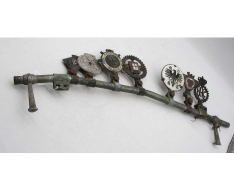 A vintage car badge bar, mounted with seven vintage badges to include The Royal Automobile Club Begique and RAC