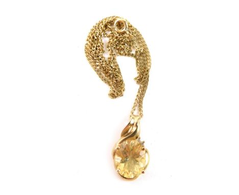 A 9ct gold citrine and diamond pendant and chain,  the twist design pendant set with an oval citrine in four claw setting, wi