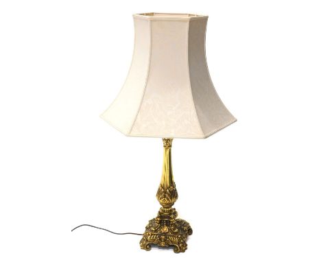 An 20thC rococo table lamp,  with cream shade, and an acanthus leaf stem, on platform, terminating in scroll feet, 84cm high.