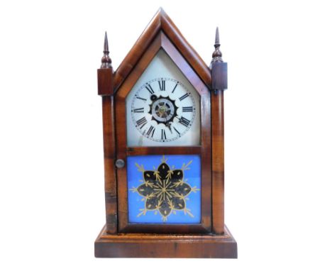 A late 19thC American wall clock by the Waterbury Clock Company, in mahogany case, with white painted dial and alarm, the cas