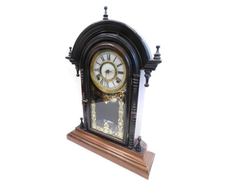 A late 19thC American mantel clock, in walnut and rosewood case, the arched top set with three finials, above a white paper d
