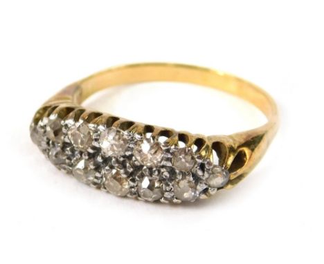 A diamond dress ring,  set with twelve, old cut tiny diamonds, each in a illusion setting, on a yellow metal band, unmarked, 