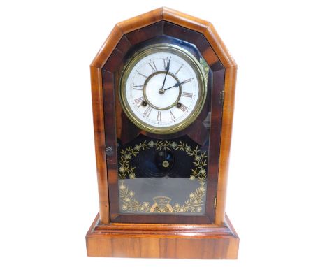 A late 19thC American mantel clock, in figured walnut case with arched top, the paper dial stamped The New Haven Clock Compan