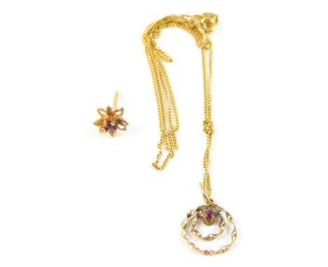 A 9ct gold pendant and chain, the circular pendant with two row twists set with tiny garnet, and on fine link neck chain, wit