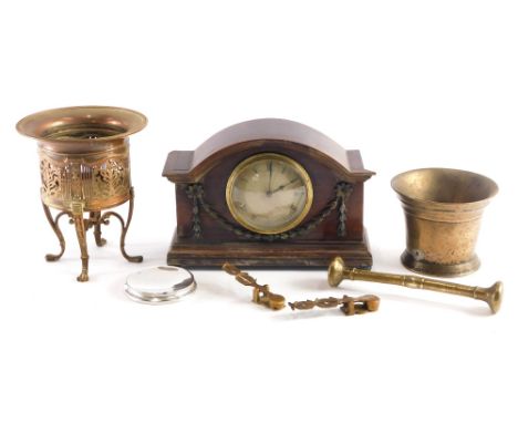 An early 20thC mahogany cased mantel clock, with raised garland decoration, the domed front revealing a 9cm diameter Roman nu