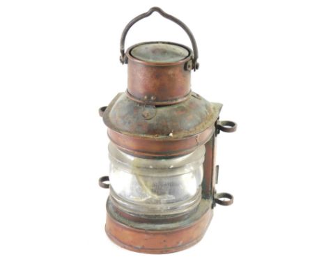 An early 20thC copper ships light, of D-end form with swing handle and glazed front, the main body, 22cm high.