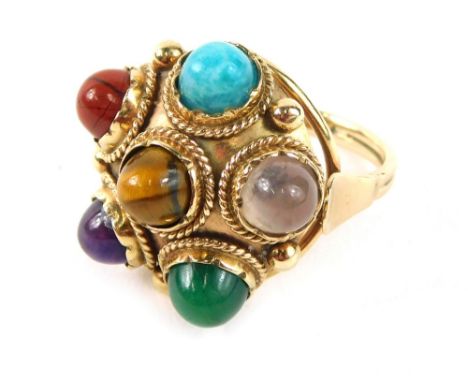 An Eastern inspired multi stone dress ring, of circular form set with turquoise, tigers eye, jade, amethyst, moonstone, and r