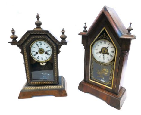 A late 19thC American mantel clock, in a figured mahogany arched case with turned finials, the paper dial enclosed by a black