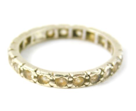 A 9ct gold and silver eternity ring,  set with white spinels, on a white gold and silver setting, misshapen, ring size M 2g a