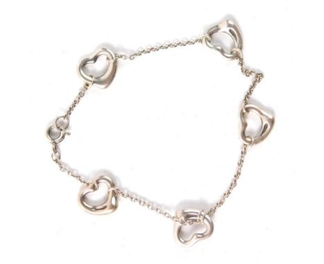 A silver bracelet, set with five love heart charms on a fine link chain, stamped 925, in Tiffany and Co box, 11cm long, 4.8g 