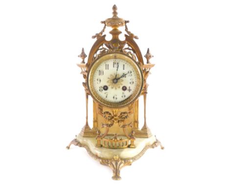 An early 20thC gilt metal and marble finish mantel clock, with 9cm diameter dial in elaborate case, surmounted by urns, with 