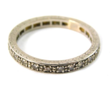 An eternity ring, set with tiny diamonds, in a white metal setting, unmarked, possibly silver, ring size O, 3.6g all in.