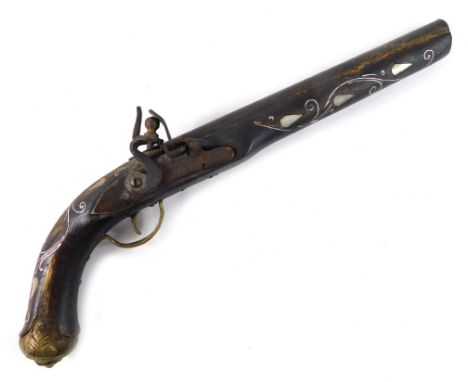 A 19thC Eastern flintlock pistol, with mother of pearl inlay, metal trigger and end, 41cm long.