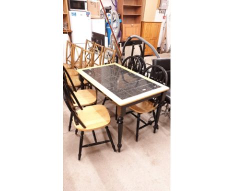 Modern kitchen table with black tile effect with 4 chairs. 
