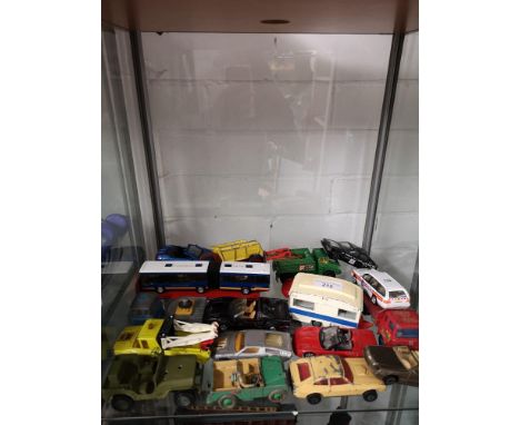 Shelf of playworn vehicles includes corgi caravan vehicle. 