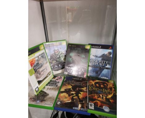 Shelf of xbox and playstation games etc. 