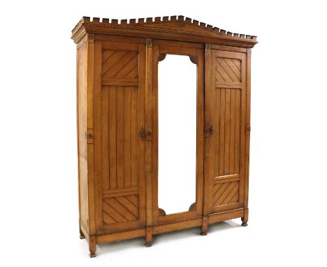 An ash press in the Arts &amp; Crafts style,late 19th century, in the manner of Charles Bevan, with a castellated cornice ove