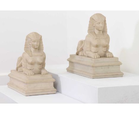A pair of imitation marble sphinx figures,of recent manufacture, in 19th century style, each on a rectangular plinth,33cm wid