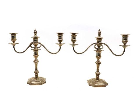 A pair of silver candelabra,by Barker Ellis Silver Co, Birmingham 1972, twin scroll branches, raised on loaded stepped bases3