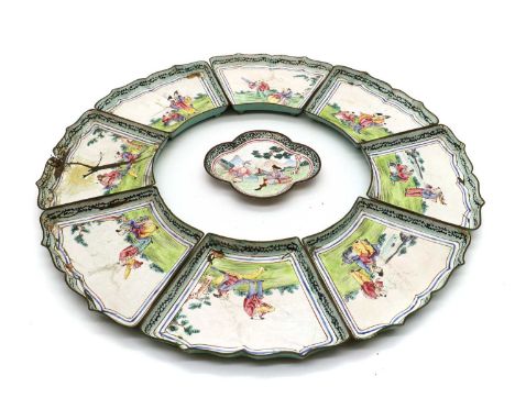 A Chinese enamel quatrefoil dish,18th to 19th century, depicting a European man and a Chinese figure seated in a landscape,11